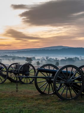 Cannons with smoky hills in the background